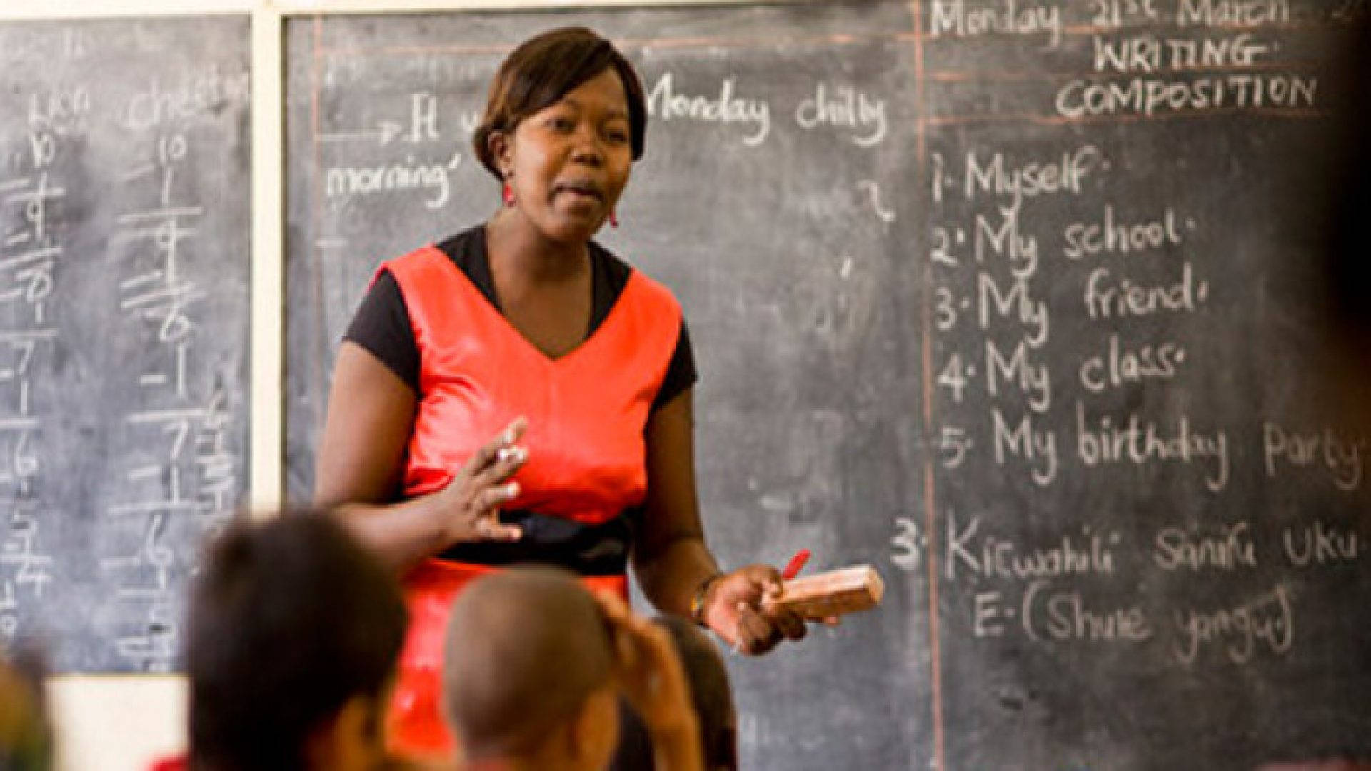 Zambian Teacher Discussing Lesson In Class Background
