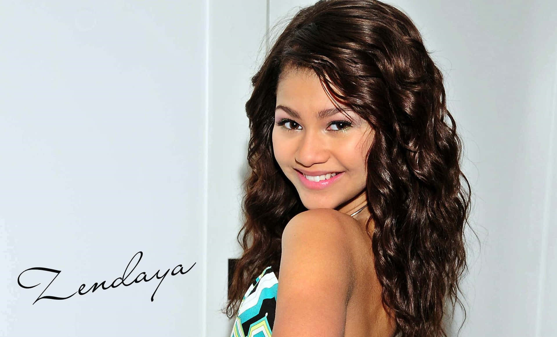 Download Actress and Singer Zendaya poses for the camera | Wallpapers.com