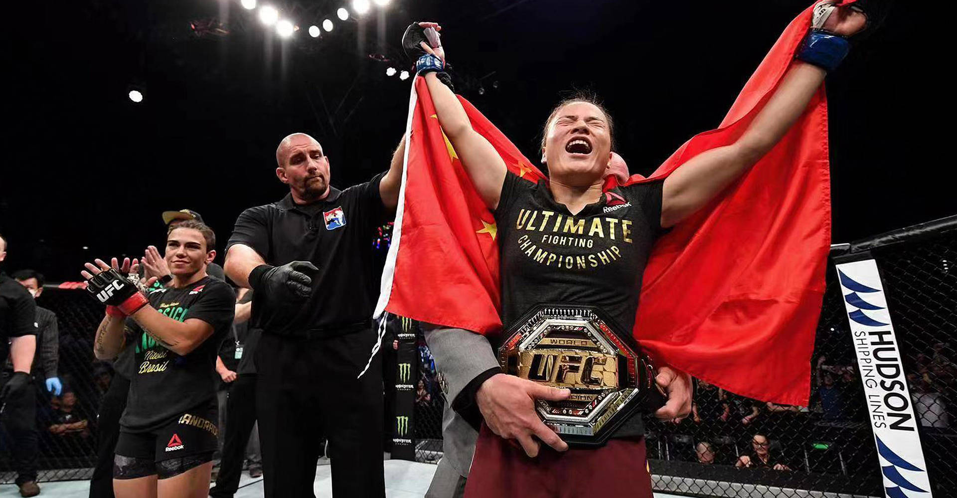 Champion Zhang Weili proudly displaying her UFC belt. Wallpaper