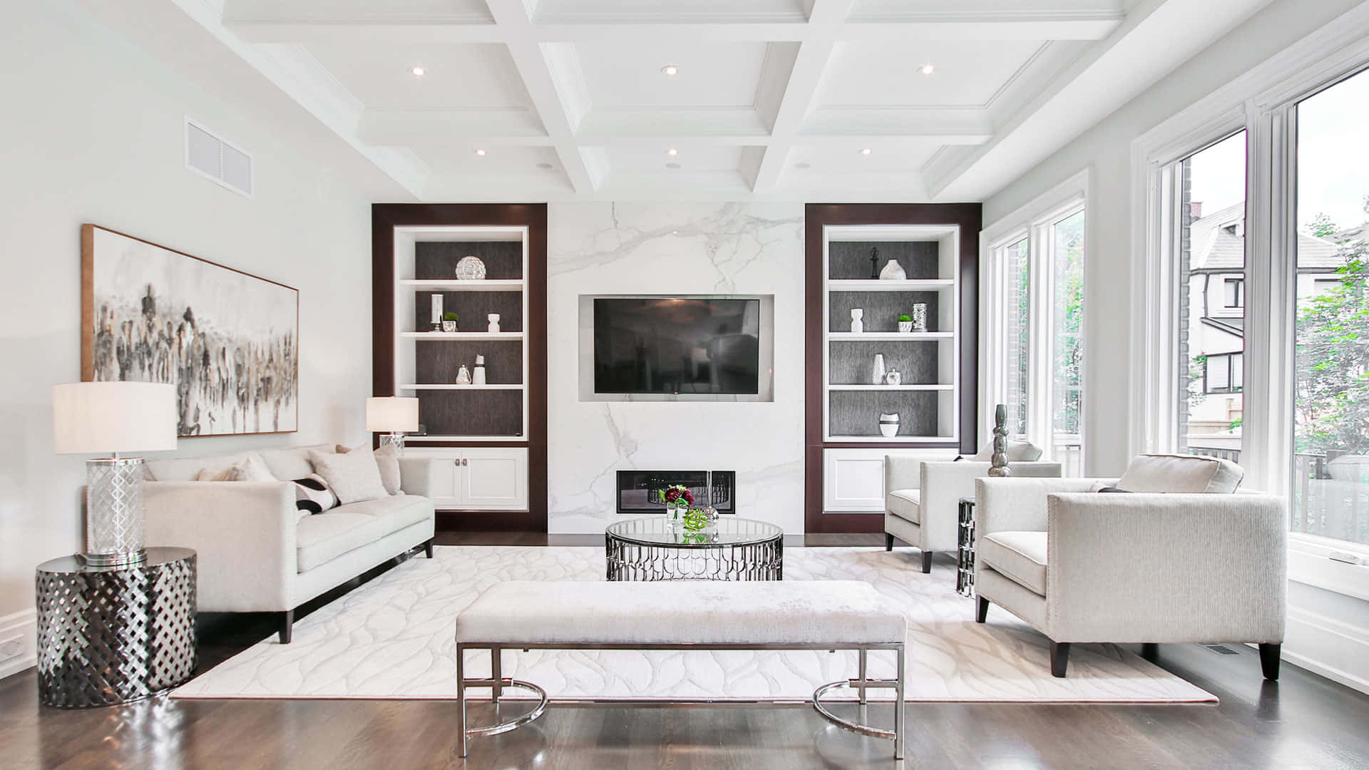 A Living Room With White Furniture And A Fireplace