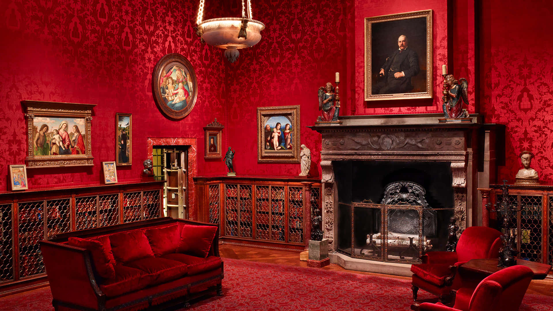 A Red Room With A Fireplace And Red Couches
