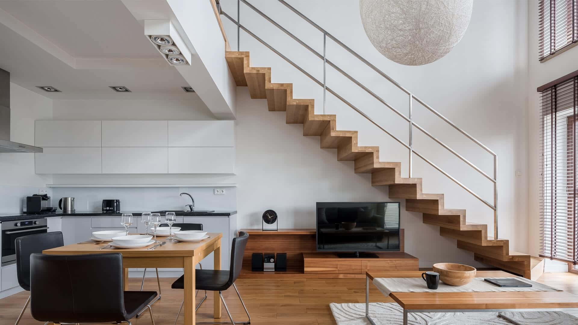 A Kitchen And Dining Area With Stairs