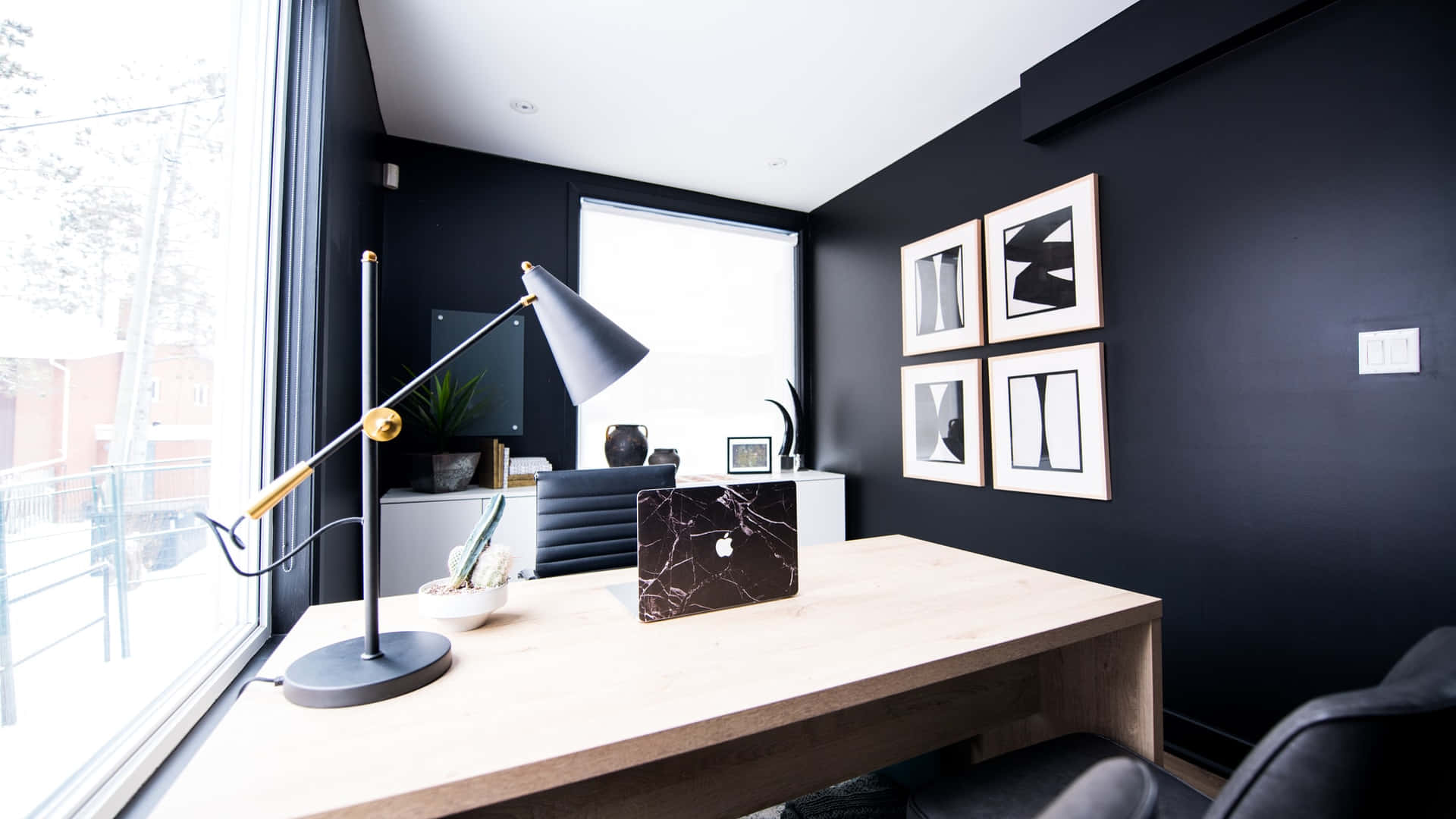 A Black Office With A Desk And A Picture