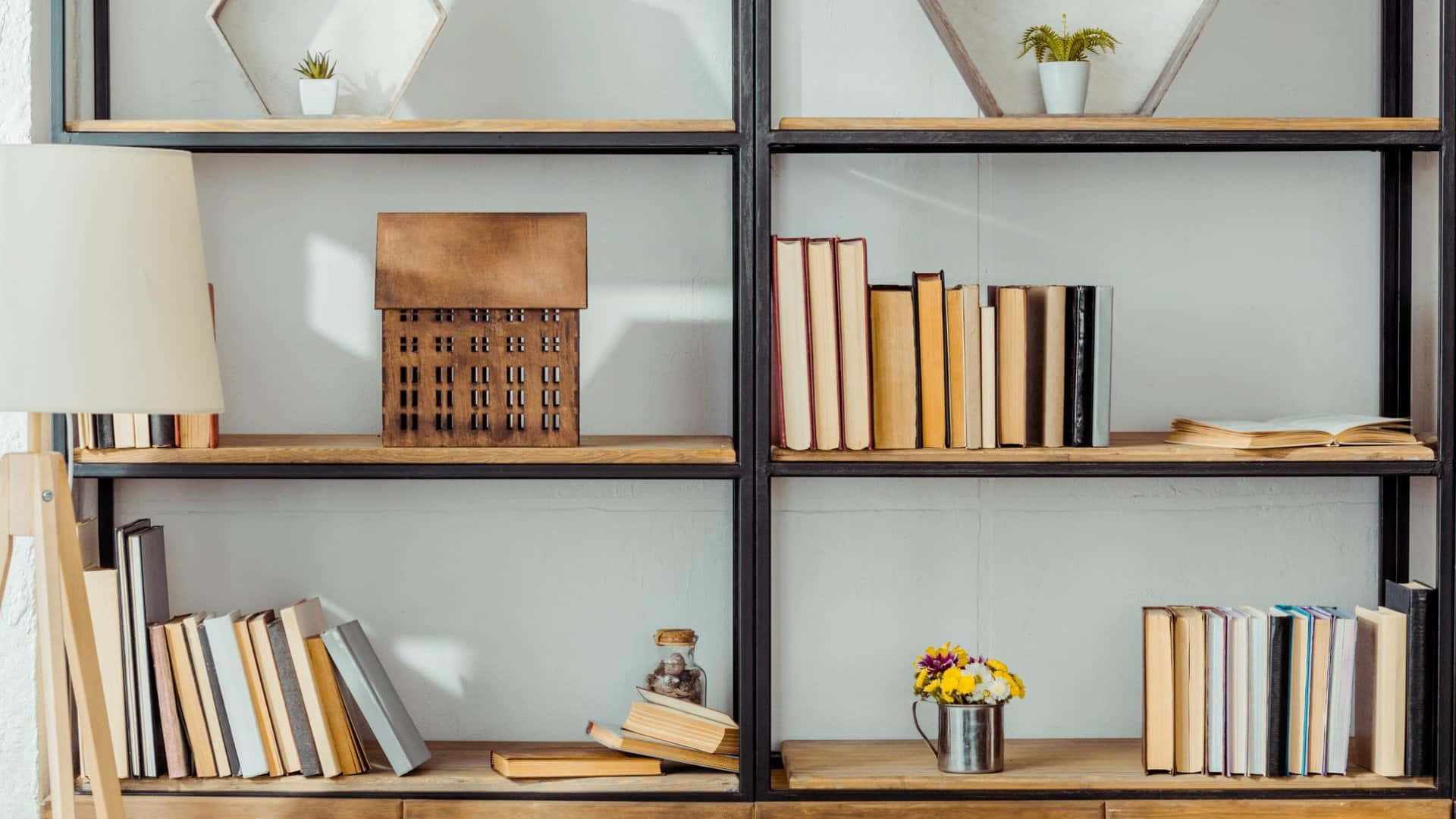 A Book Shelf With Books And A Lamp