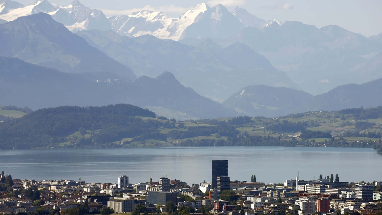 Zug Cityscapewith Snow Capped Mountains Wallpaper