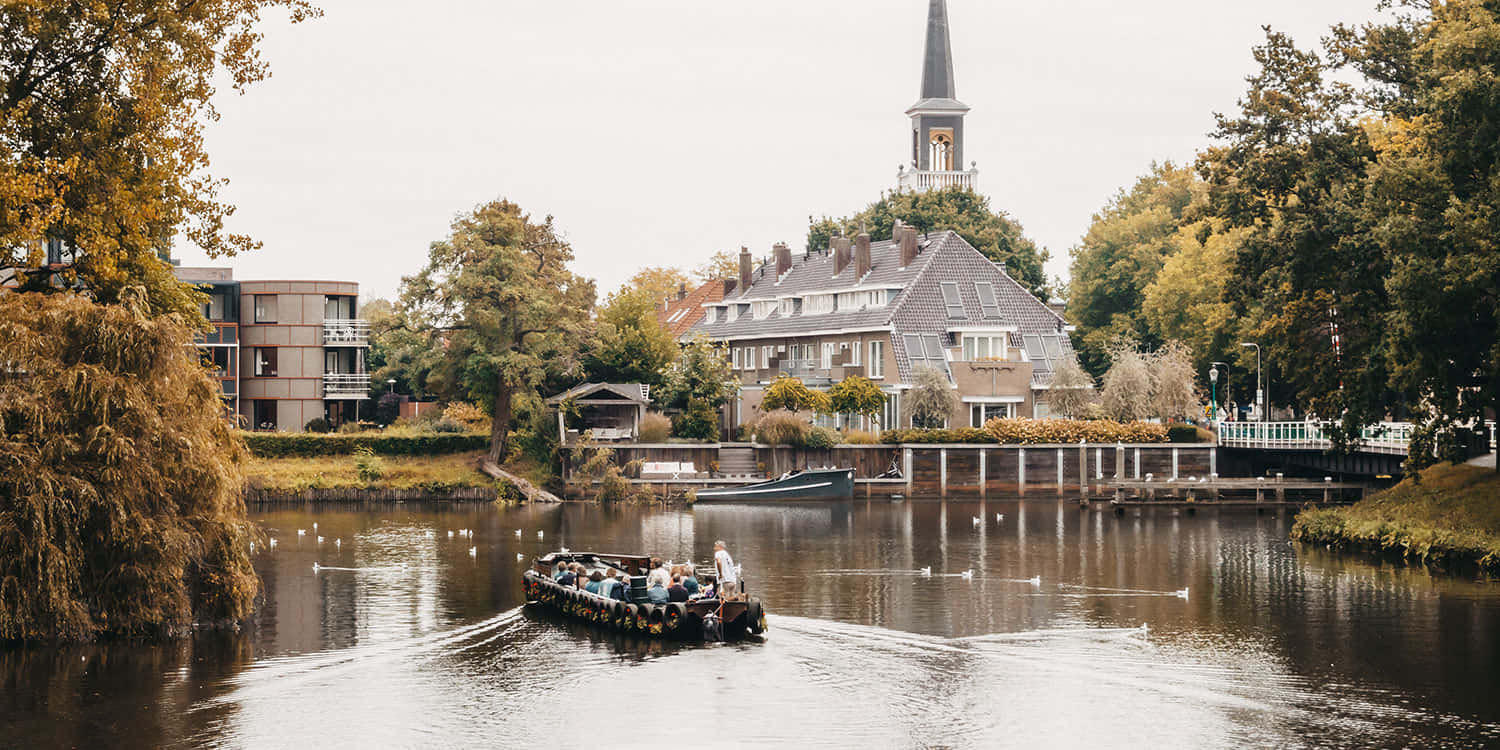 Zwolle Canal Tour With Historic Church Background Wallpaper