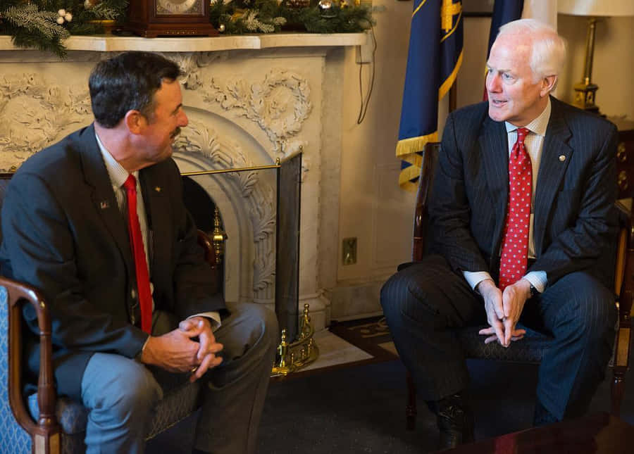 John Cornyn taler med en skægget mand, der bærer cowboyhat.