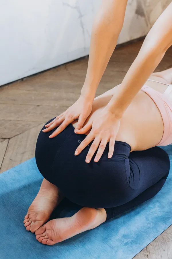 A person pressing their lower back to relieve pain