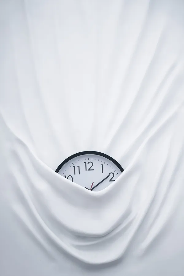 Clock on bed sheets wallpaper