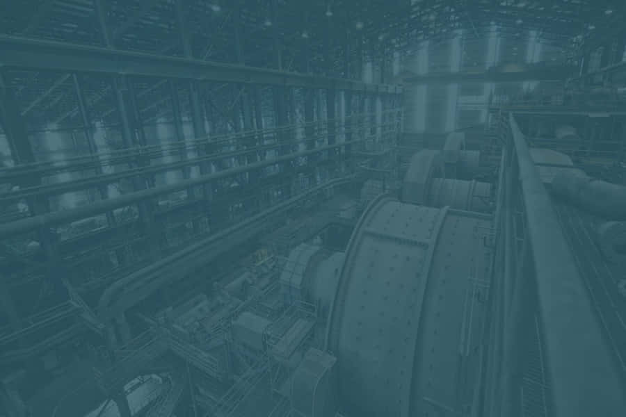 Einblaues Bild einer Fabrik mit vielen Maschinen.