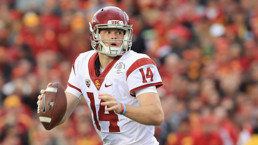 "SamDarnold American Football Player" would be translated to "Sam Darnold amerikansk fotbollsspelare" in Swedish. This could be used as a potential subject matter for a computer or mobile wallpaper for American football fans in Sweden. Other potential phrases for a sports-themed wallpaper in Swedish could include "Svenska fotbollslaget" (Swedish soccer team) or "Zlatan Ibrahimovic" (a famous Swedish soccer player).