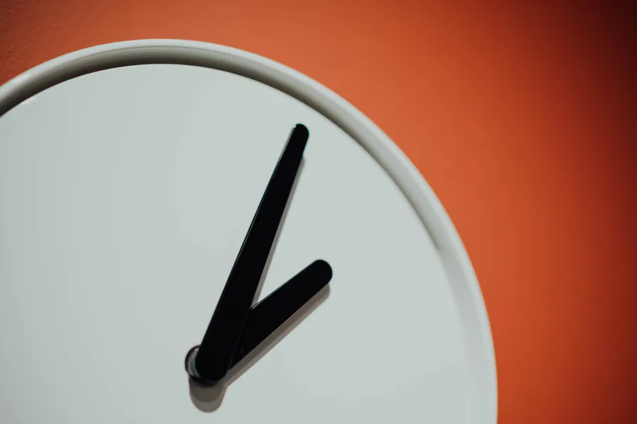 Clock on orange wall wallpaper