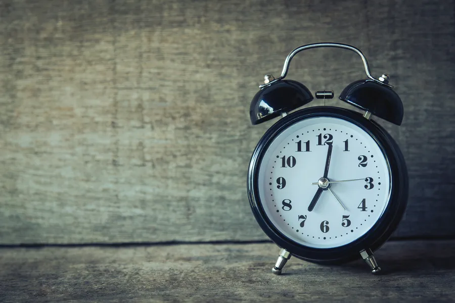 Black clock on wood wallpaper