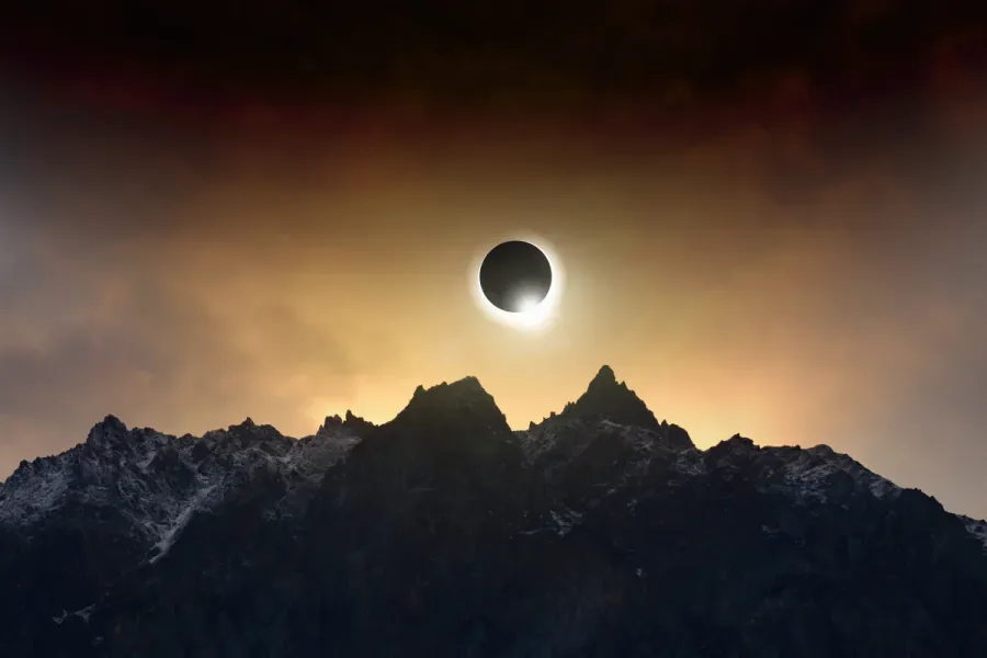 Solar Eclipse On Cloudy Mountaintop