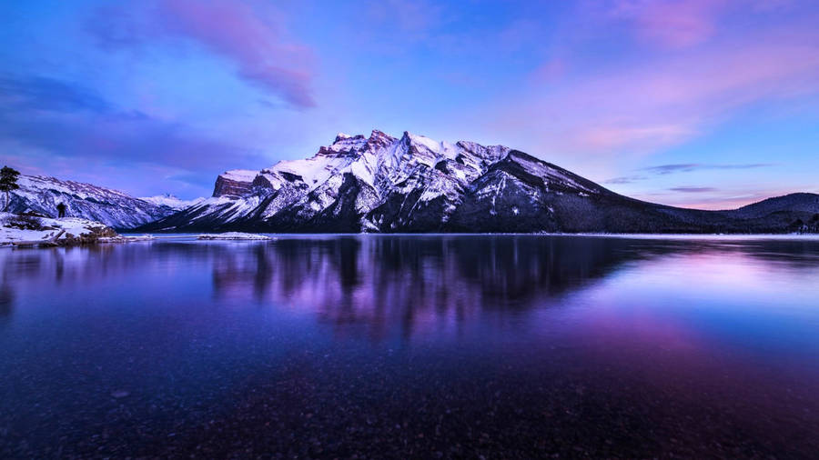 Snow-capped mountain amid aesthetic purple effects wallpaper.