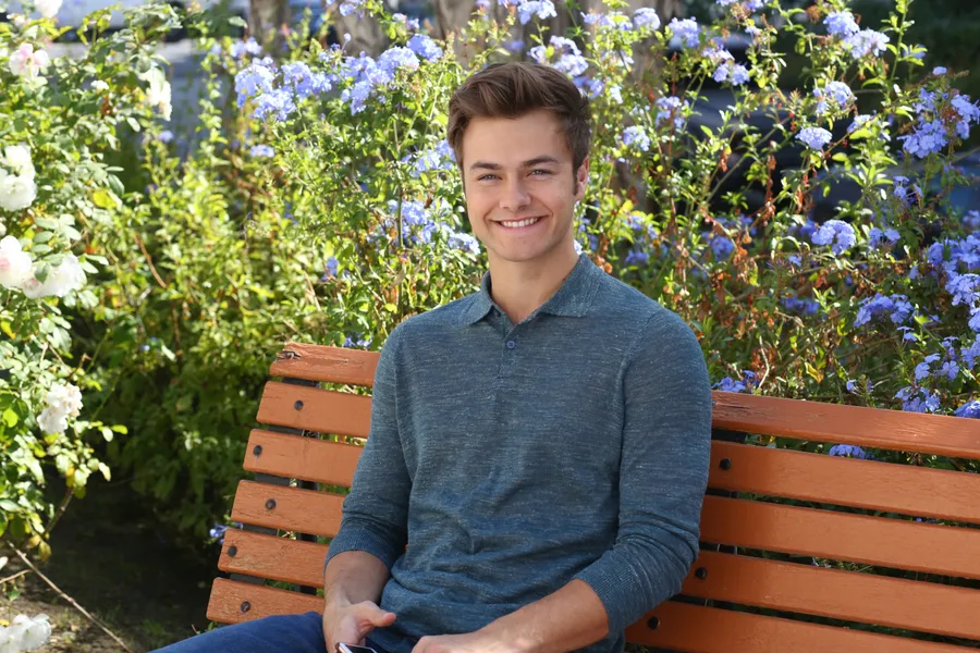 Peyton Meyer sitting on bench wallpaper