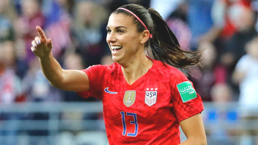 Download Alex Morgan In Red Nike Jersey Wallpaper | Wallpapers.com