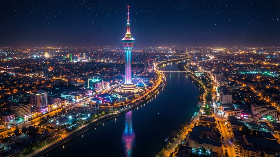 Stunning aerial night view of Baghdad with illuminated tower and river