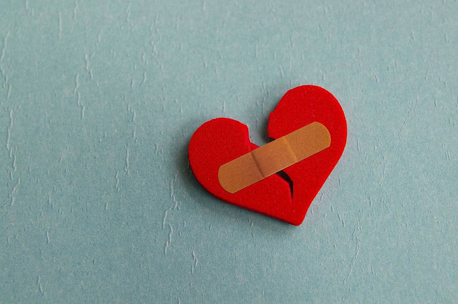 Download Break Up Band-aid Holding Heart Wallpaper | Wallpapers.com