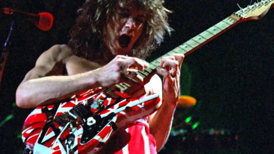 "EddieVan Halen Rock Frankenstrat Guitar" translates to "Eddie Van Halen rockar Frankenstrat-gitarren." when referring to a computer or mobile wallpaper, you could say "Ladda ner en cool Eddie Van Halen wallpaper med hans legendariska Frankenstrat gitarr." which means "Download a cool Eddie Van Halen wallpaper featuring his legendary Frankenstrat guitar."