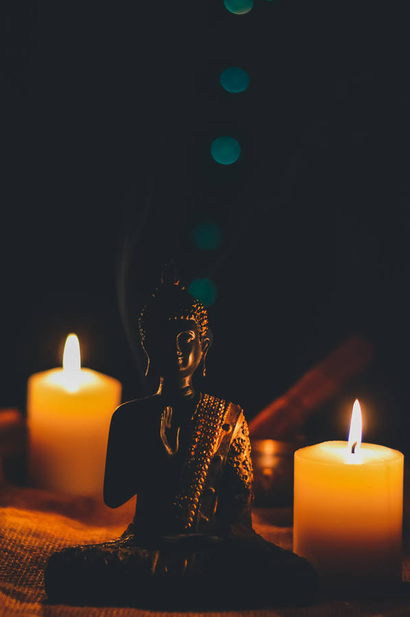 Download Buddha And Lighted Candles Wallpaper | Wallpapers.com