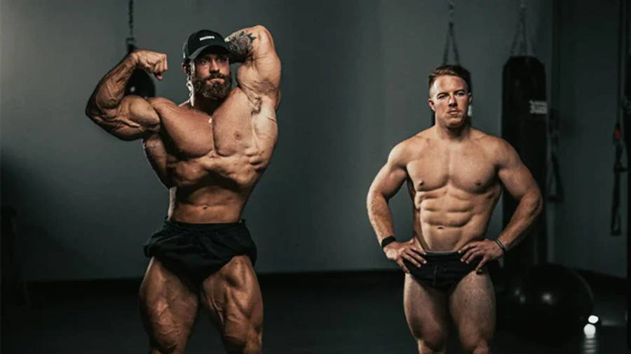 Download Chris Bumstead With Fellow Bodybuilder Wallpaper | Wallpapers.com