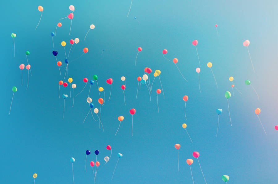 Colorful balloons at sky gradient wallpaper
