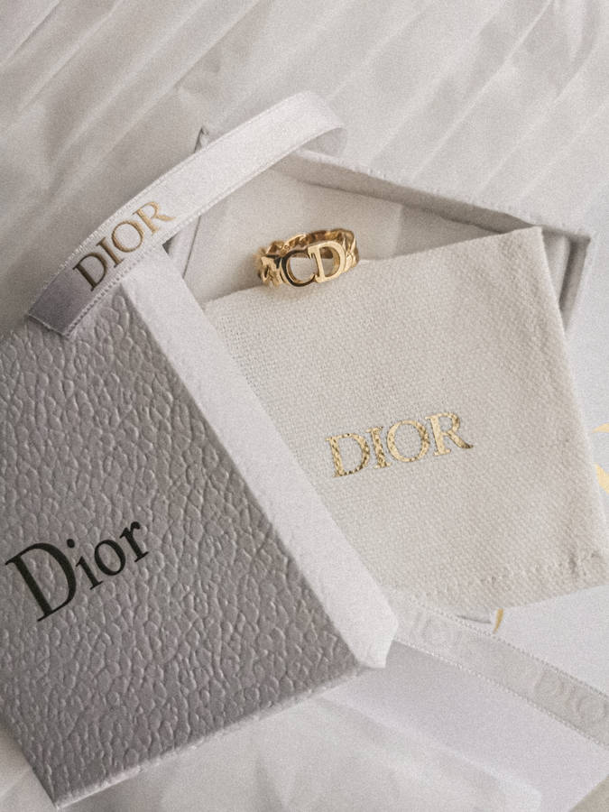 Download Dior Gold Ring And Gift Box Wallpaper