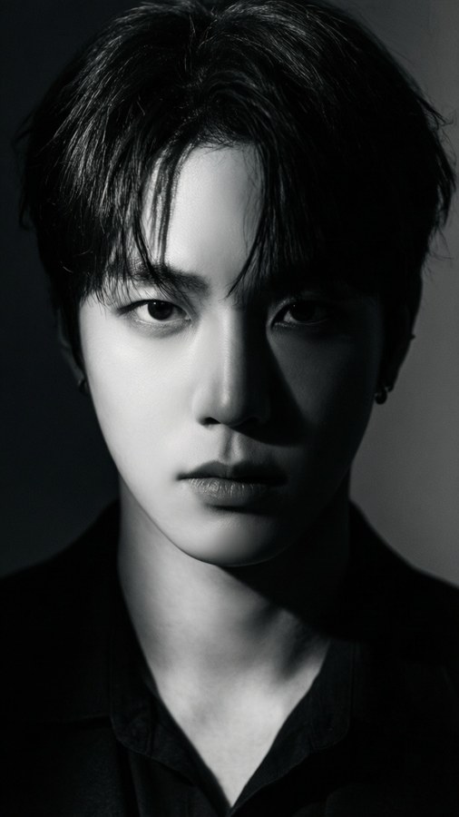 A striking portrait of The8 with dramatic side lighting and intense expression.