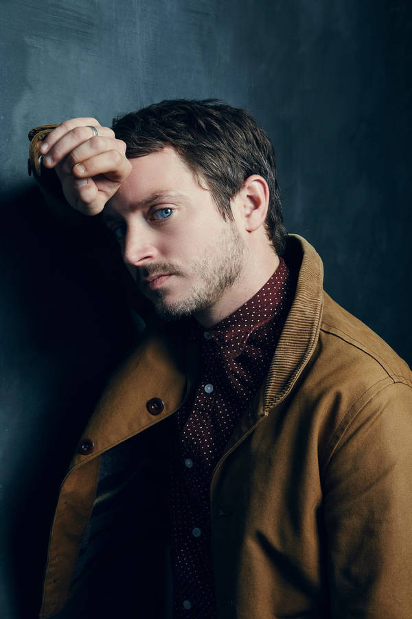 Download Elijah Wood In A Brown Denim Jacket Wallpaper | Wallpapers.com