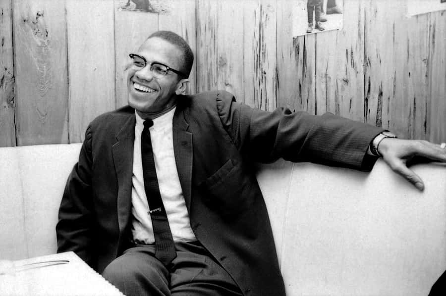 Malcolm X lächelnd in Schwarz-Weiß