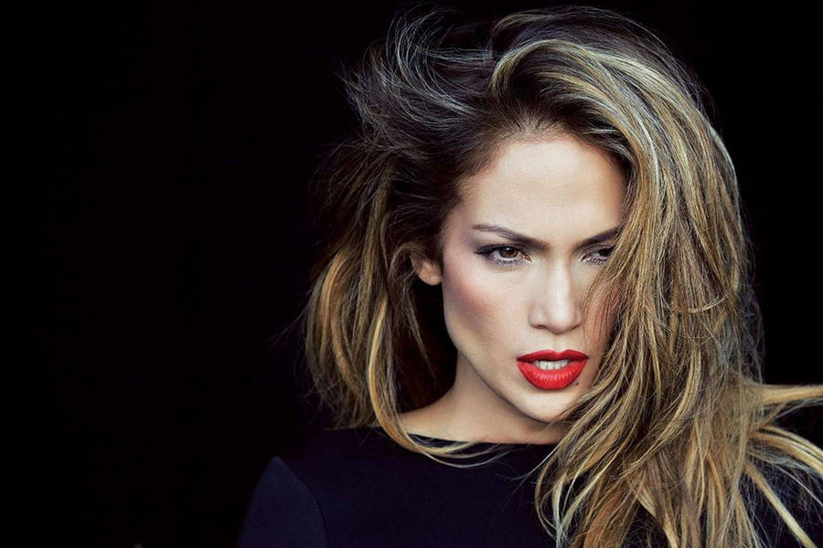 Fierce Jennifer Lopez in fringe hair and vibrant red lips wallpaper.