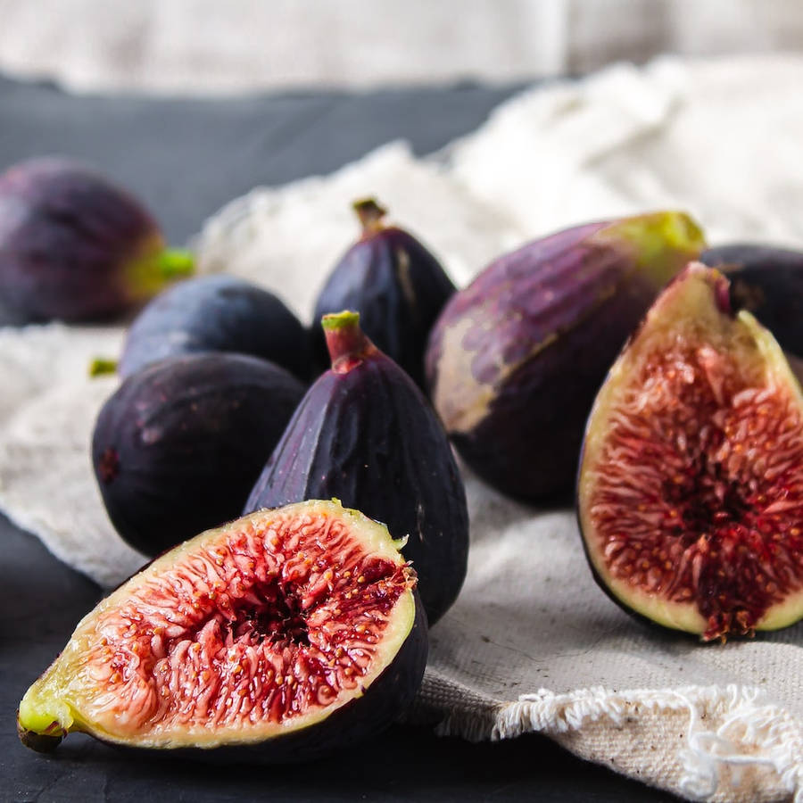 Download Fig Fruits On A Table With Burlap Sack Wallpaper | Wallpapers.com