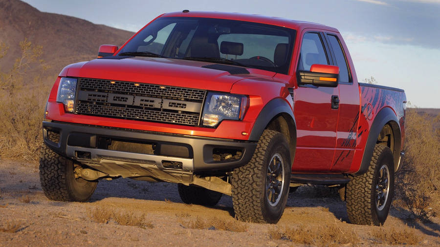 Download Ford Raptor In Metallic Orange Paint Wallpaper | Wallpapers.com