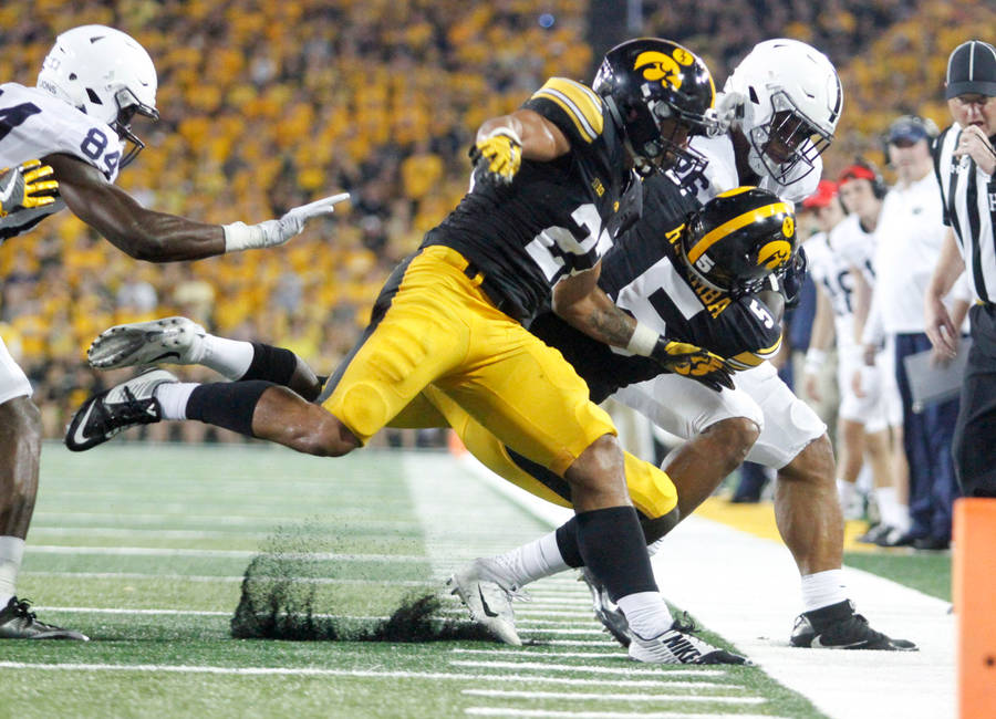 Download Iowa Hawkeyes Tackle Wallpaper | Wallpapers.com