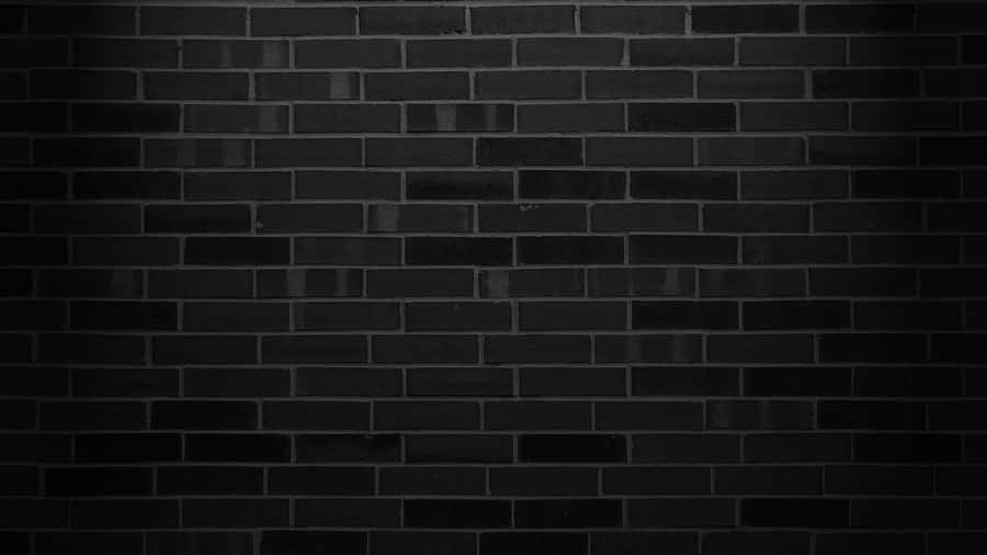 schwarzeZiegelwand Hintergrundfoto