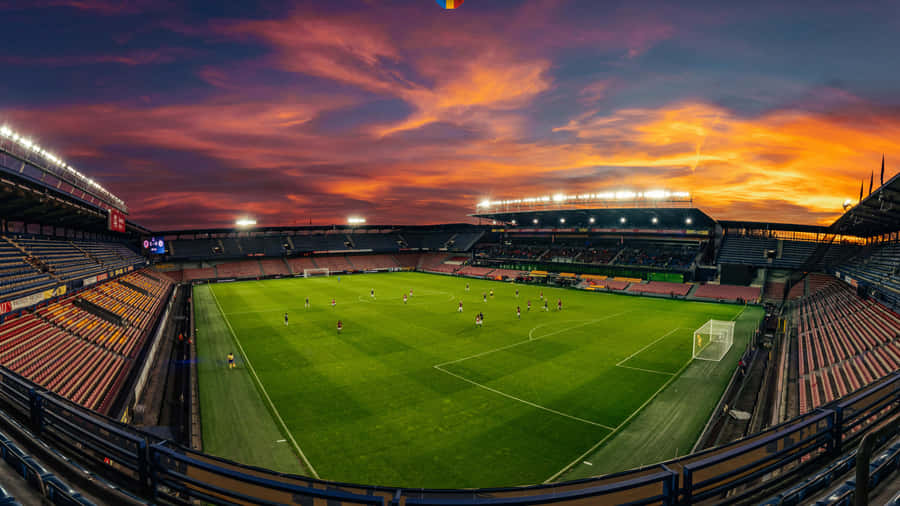 unostadio di calcio con un cielo al tramonto