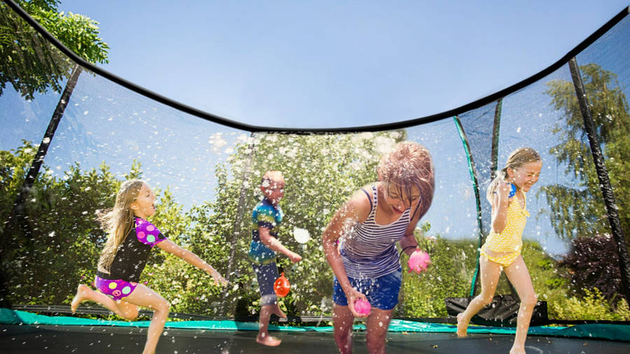Download Kids Playing Inside A Trampoline Wallpaper | Wallpapers.com