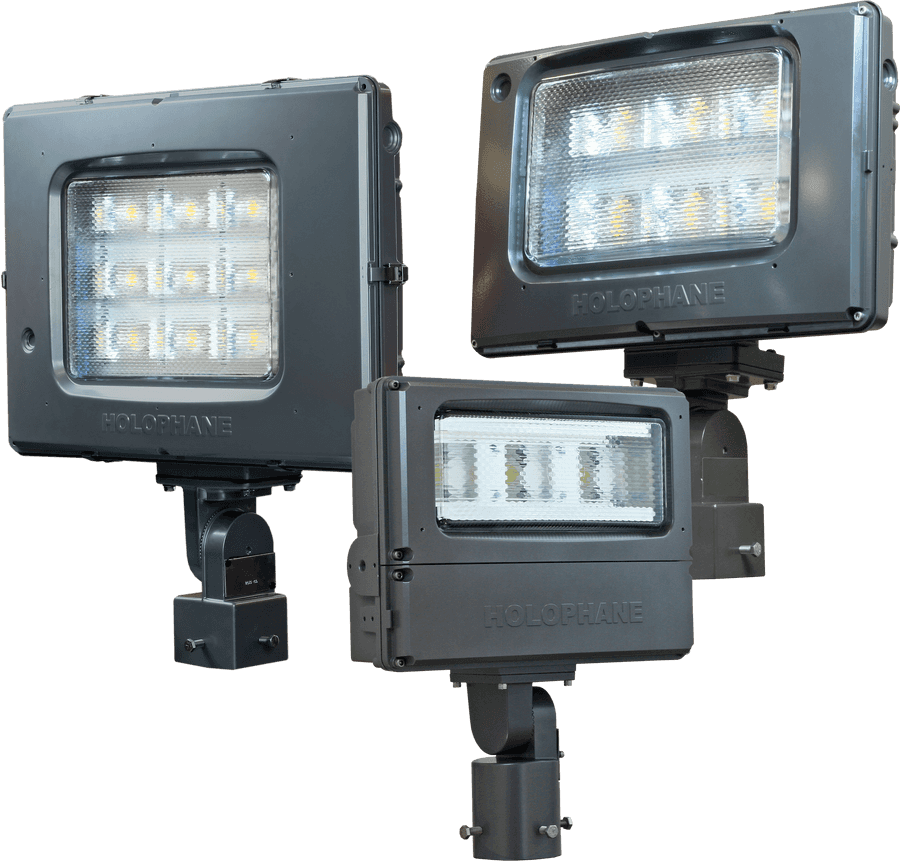 L E D Stadium Lights Array PNG — Three gray Holophane LED floodlights with illuminated panels and mounting brackets shown against black background.
