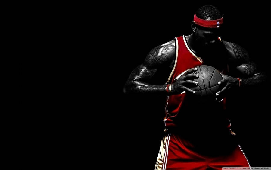 Lebron James holding a ball on black background wallpaper