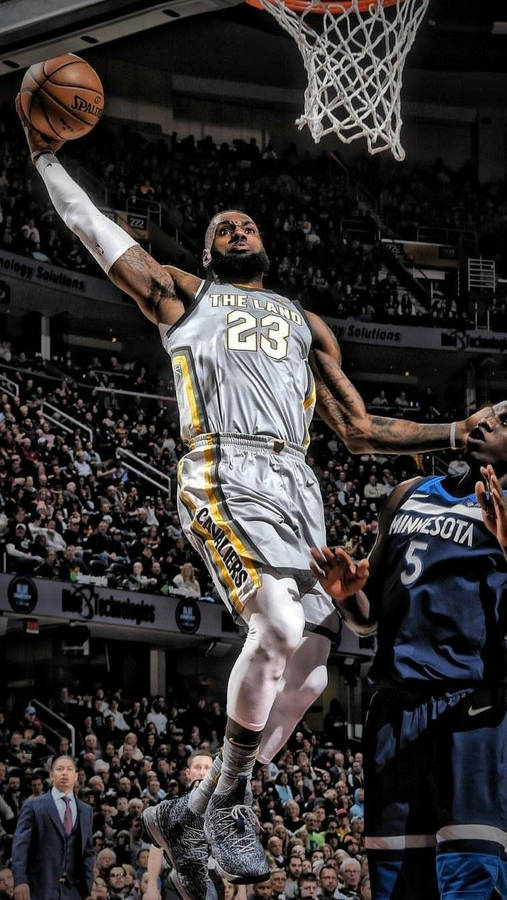 Lebron James in his NBA The Land 23 jersey doing a slam dunk wallpaper
