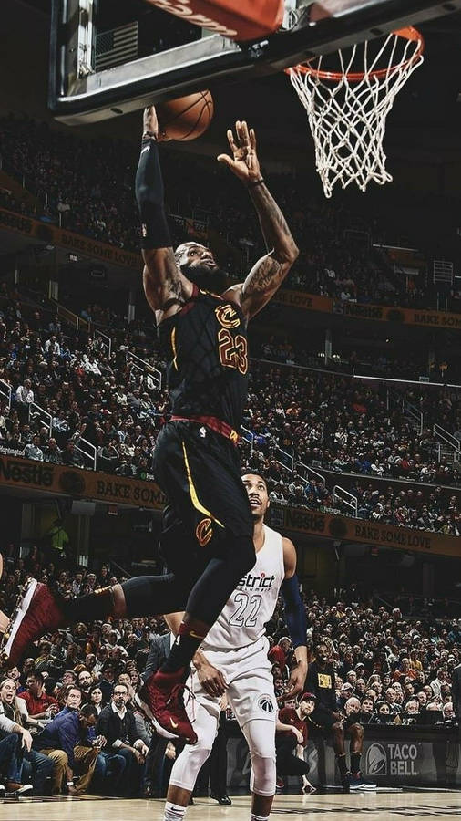 Lebron James wearing jersey number 23 in mid-air doing a slam dunk wallpaper