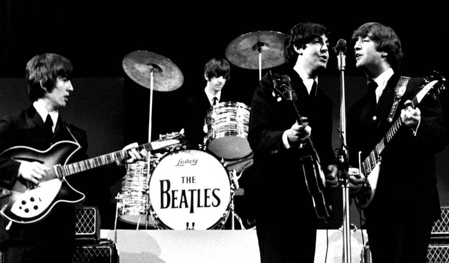 Image of The Beatles doing a live performance wallpaper.