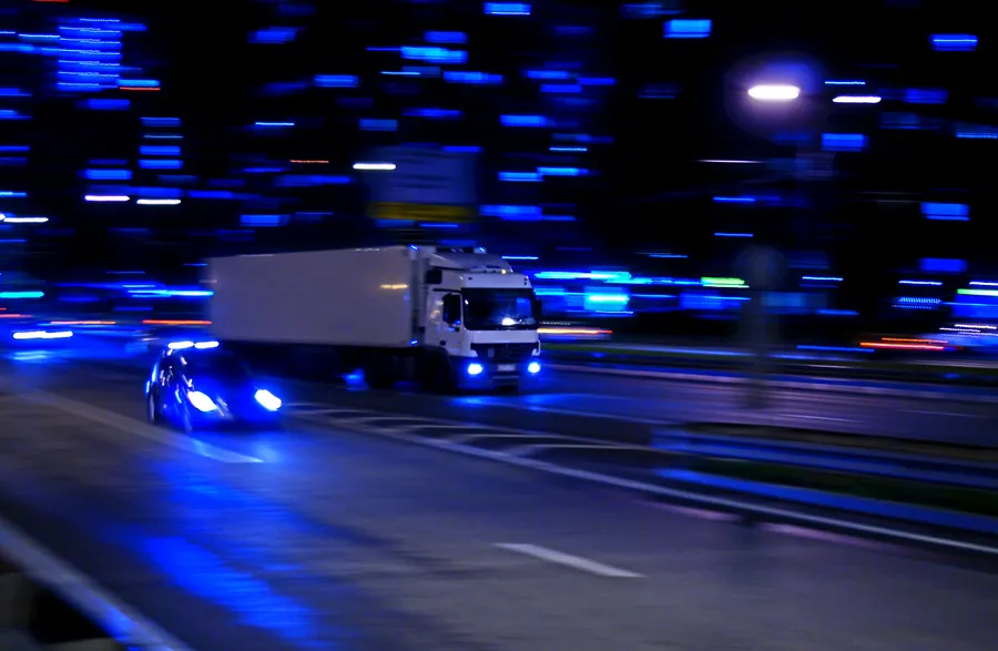 white and black bus on road during night time