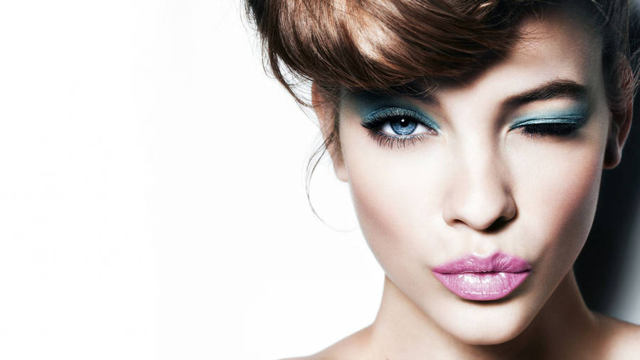 Classy makeup look using a blue eyeshadow and pink gloss lipstick wallpaper.