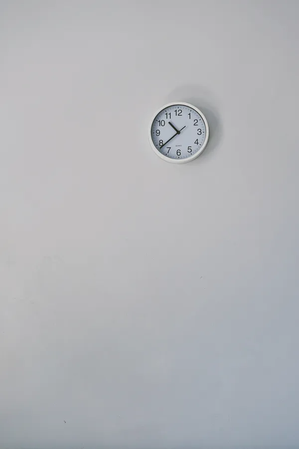 Clock on white wall wallpaper