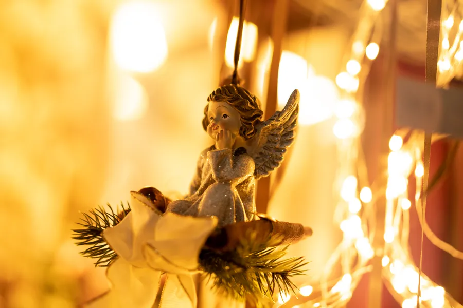 gold angel figurine on gold christmas tree