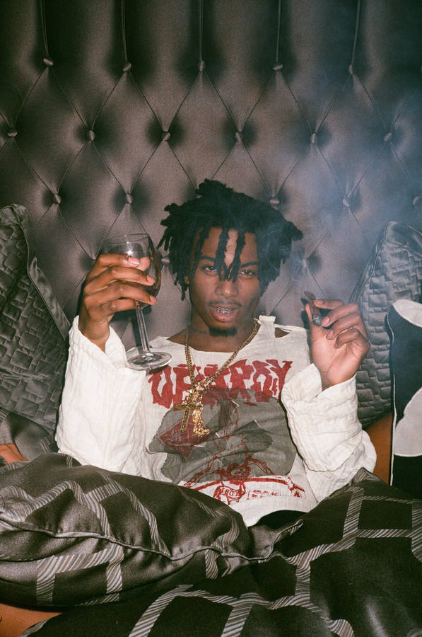 Download Playboi Carti In Bed Wallpaper | Wallpapers.com