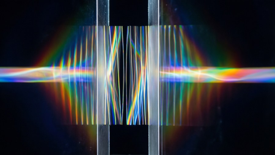 Double-slit experiment pattern with scientific quote.