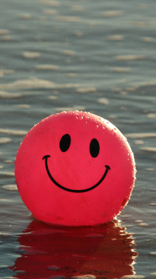 Download Red Smiley Emoji Balloon Wallpaper | Wallpapers.com